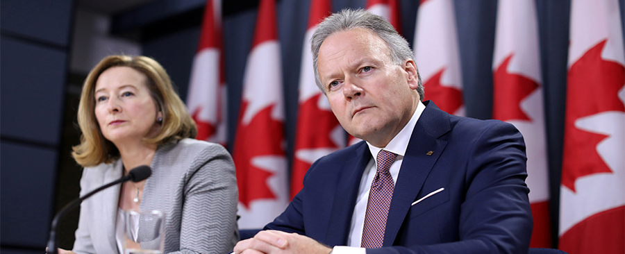 Stephen Poloz and Senior Deputy Governor Carolyn Wilkins listening during a news conference.