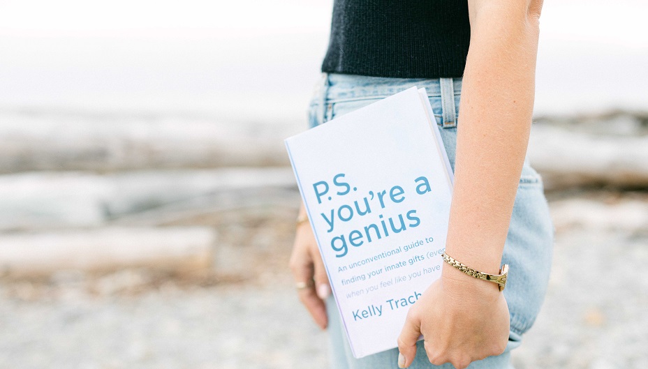 Author Kelly Trach holds a copy of her book, P.S. You're a Genius. 