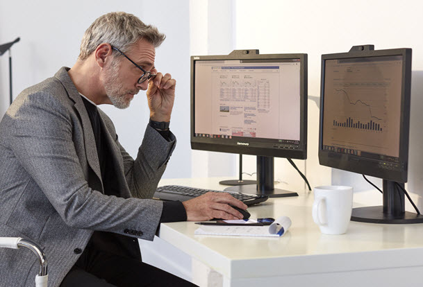 Man looking at desktop screen. 