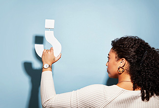 Woman holding question mark