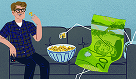 Man sitting on couch with a Canadian bill. 