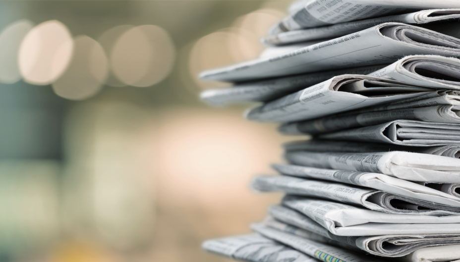 A close-up photo of a stack of newspapers.