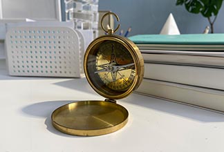 Compass placed on a desk.