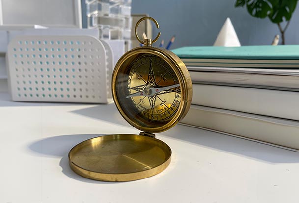 A compass sitting open on a desk