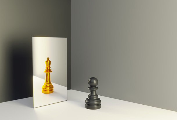 A black pawn and a gold king chess piece